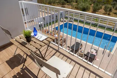 a deck with a table and chairs next to a pool at Ayia Napa Bay View Villa 5 in Ayia Napa