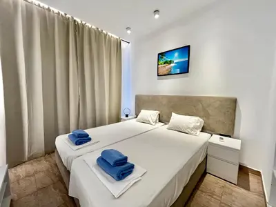 a bedroom with two blue towels on a bed at STAY Napa Velvet Apartment in Ayia Napa