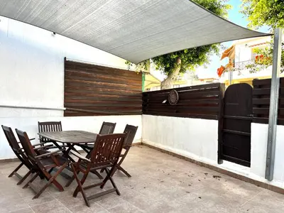 a patio with a table and chairs under a canopy at STAY Napa Velvet Apartment in Ayia Napa