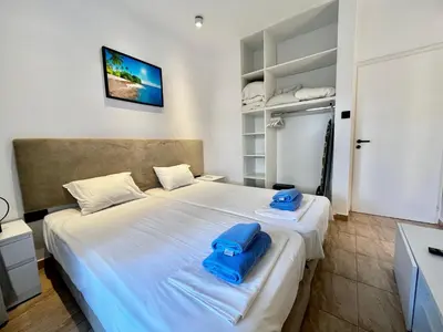 a bedroom with a large bed with blue towels on it at STAY Napa Velvet Apartment in Ayia Napa