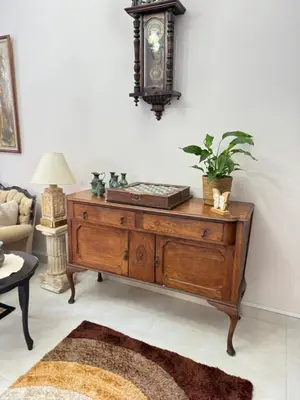 a living room with a wooden dresser with a plant on it at Διαμέρισμα ισόγειο για ενοικίαση in Limassol