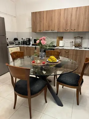 a kitchen with a table with a bowl of fruit on it at Διαμέρισμα ισόγειο για ενοικίαση in Limassol