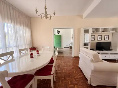 a living room with a white table and chairs at Green Door 3bdr flat City Centre in Nicosia