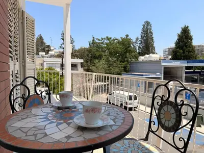 a table on a balcony with two cups of coffee at Green Door 3bdr flat City Centre in Nicosia