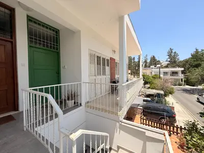 a balcony of a house with a green door at Green Door 3bdr flat City Centre in Nicosia