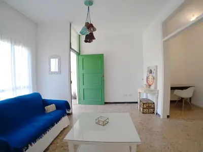 a living room with a blue couch and a green door at Green Door 3bdr flat City Centre in Nicosia