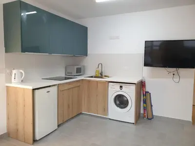 a kitchen with a washing machine and a sink at Studio In the Centre of the city in Ayia Napa