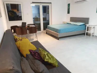 a living room with a couch and a bed at Studio In the Centre of the city in Ayia Napa