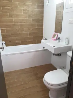 a bathroom with a tub and a toilet and a sink at Studio In the Centre of the city in Ayia Napa