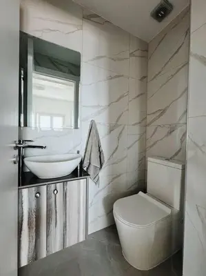 a bathroom with a sink and a toilet and a mirror at 3 Br Penthouse Jacuzzi Seaview in Limassol