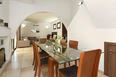 a dining room and living room with a table and chairs at Villa Evia - Walking to Med Sea in Ayia Napa