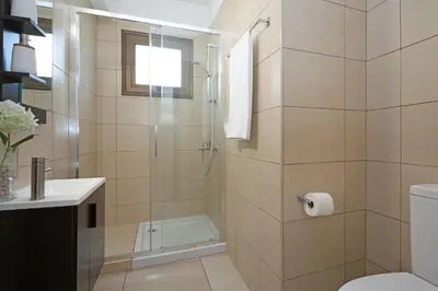 a bathroom with a shower with a toilet and a sink at Villa Evia - Walking to Med Sea in Ayia Napa