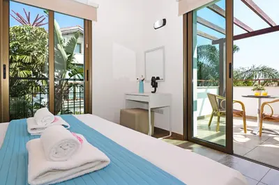 a bedroom with a bed with towels on it at Villa Evia - Walking to Med Sea in Ayia Napa