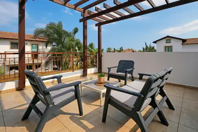a patio with two chairs and a table on a balcony at Villa Evia - Walking to Med Sea in Ayia Napa