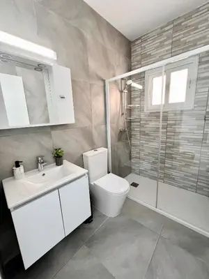 a bathroom with a toilet and a sink and a shower at Georgiou 202 in Larnaka