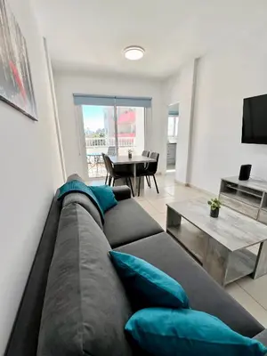 a living room with a couch and a table at Georgiou 202 in Larnaka
