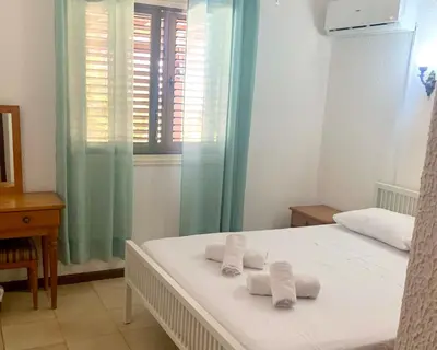 a bedroom with a bed with towels on it at Sandy Beach Villas Sea View Apartment Pyla in Larnaka