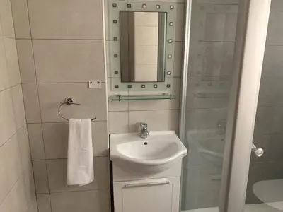 a small bathroom with a sink and a mirror at Sandy Beach Villas Sea View Apartment Pyla in Larnaka