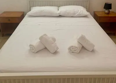 a bed with three rolled towels on it at Sandy Beach Villas Sea View Apartment Pyla in Larnaka