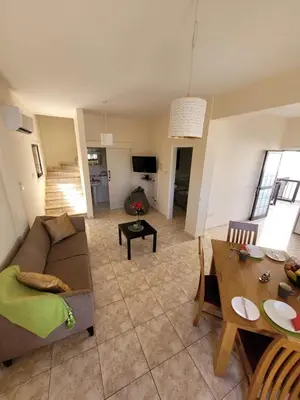 a living room with a couch and a table at Ayia Napa Marina Luxury Villas - Pearl in Ayia Napa