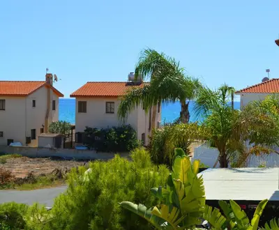 a row of houses with the ocean in the background at Ayia Napa Marina Luxury Villas - Pearl in Ayia Napa