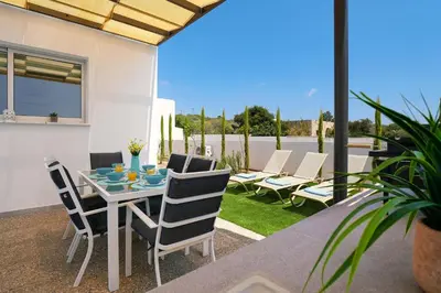 a patio with a table and chairs on a patio at Villa Rosaleen - Ayia Napa Resort Center in Ayia Napa