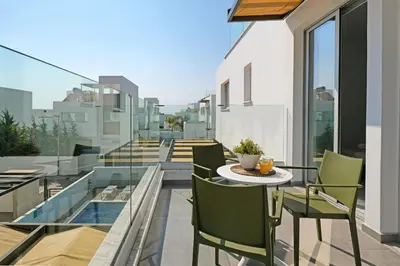 a balcony with a table and chairs on a building at Villa Rosaleen - Ayia Napa Resort Center in Ayia Napa