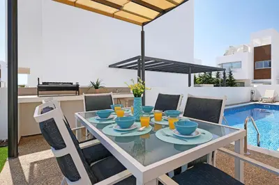 a dining table with cups and drinks on a patio at Villa Rosaleen - Ayia Napa Resort Center in Ayia Napa
