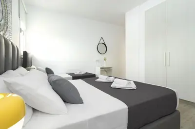 a bedroom with two beds and a mirror at Villa Evelin - Ayia Napa Resort Center in Ayia Napa