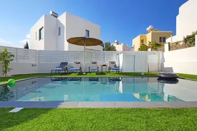 a swimming pool in the yard of a house at Villa Merope - 3Bed All En-suite in Paralimni