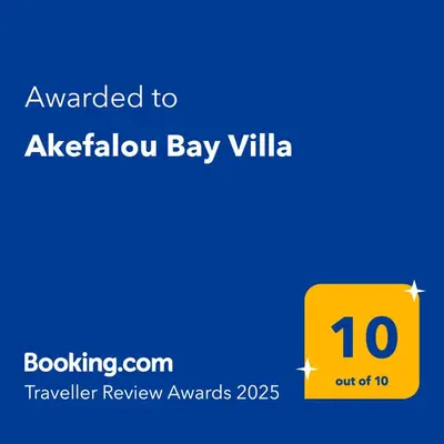 a yellow sign with the text awarded to akelux bay villa at Akefalou Bay Villa in Protaras