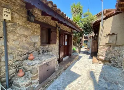 a stone building with a door on a street at House No9 - Studio in Kakopetria