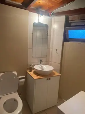 a bathroom with a white toilet and a sink at House No9 - Studio in Kakopetria