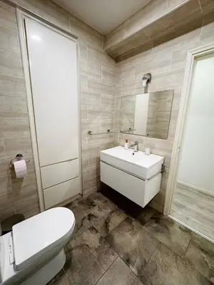 a bathroom with a white sink and a toilet at Sea view 3 bedrooms apartment in Limassol