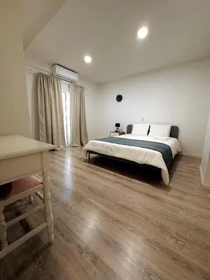 a large bedroom with a bed and a table at Sea view 3 bedrooms apartment in Limassol