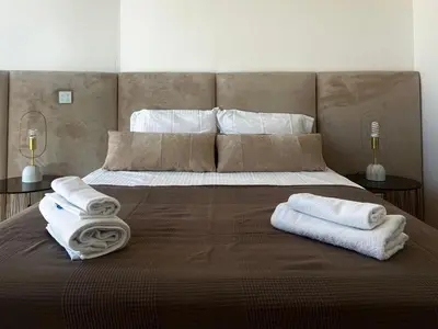 a bedroom with a large bed with towels on it at Nicosia 360 Luxury Living A in Nicosia