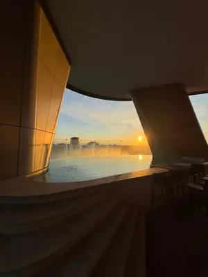 a view of a pool from a building with a sunset at Nicosia 360 Luxury Living A in Nicosia