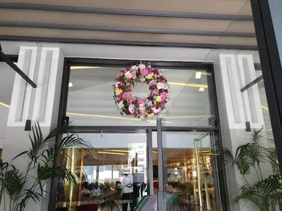 a wreath of flowers is hanging in a store window at Nicosia 360 Luxury Living A in Nicosia