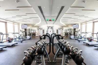 a gym with rows of treadmills and machines at Nicosia 360 Luxury Living A in Nicosia