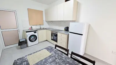 a kitchen with a white refrigerator and a dishwasher at Sky Ward City Rooms, 150m from Chabad Lubavitch in Larnaka