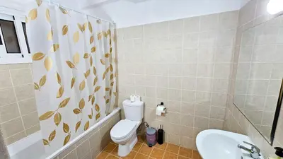 a bathroom with a toilet and a sink at Sky Ward City Rooms, 150m from Chabad Lubavitch in Larnaka