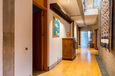 a hallway with white walls and wooden floors at Paradise Peek, Platres in Platres