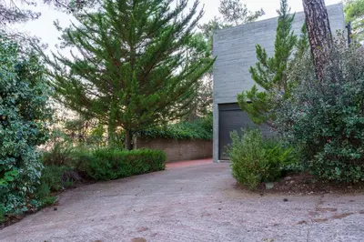 a house with a garage and some trees at Paradise Peek, Platres in Platres