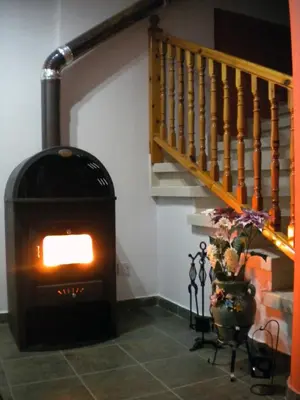 a fireplace in a room with a staircase at JP Pool House in Trimiklini