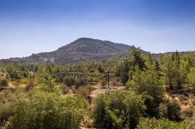 a mountain in the distance with trees in the foreground at JP Pool House in Trimiklini