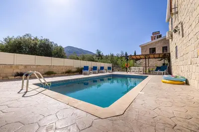 a swimming pool with a raft in the middle at JP Pool House in Trimiklini
