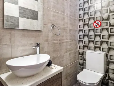 a bathroom with a white sink and a toilet at Andre Marie Stonewood Retreat in Limassol