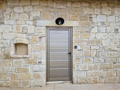 a stone wall with a door in front of it at Andre Marie Stonewood Retreat in Limassol