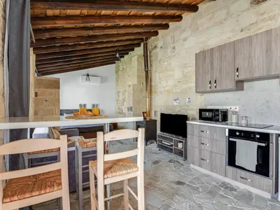a kitchen with a counter and some chairs in it at Andre Marie Stonewood Retreat in Limassol