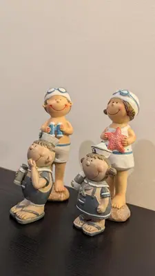 a group of figurines of people on a shelf at Kama Lifestyle Modern apt with sea view in Protaras